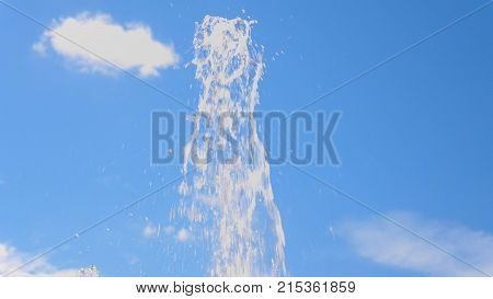 Top Fountain Water Against On The Blue Sky.
