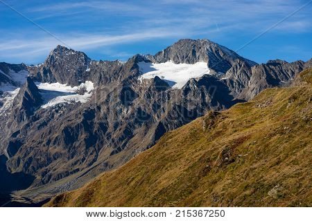 Mountains peaks and trees landscape natural environment. Timmelsjoch High Alpine Road. Passo del Rombo the highest pass of the Eastern Alps. Ötztal valley Tyrol Austria Europe
