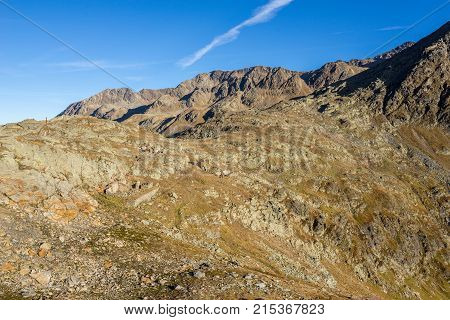 Timmelsjoch High Alpine Road landscape. Mountains and peaks covered with glaciers and snow natural environment. Hiking in the Passo del Rombo. Ötztal alps Austria and Italy border Europe