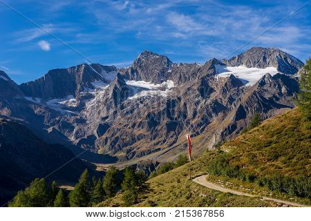 Timmelsjoch High Alpine Road landscape. Mountains and peaks covered with glaciers and snow natural environment. Hiking in the Passo del Rombo. Ötztal alps Austria and Italy border Europe