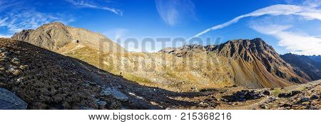 Timmelsjoch High Alpine Road landscape panorama. Mountains and peaks covered with glaciers and snow natural environment. Hiking in the Passo del Rombo. Ötztal alps Austria and Italy border Europe