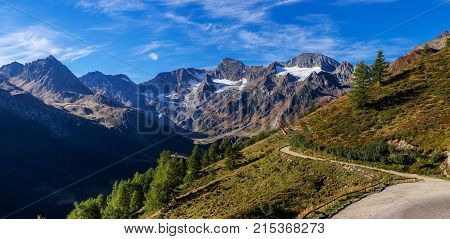 Timmelsjoch High Alpine Road landscape panorama. Mountains and peaks covered with glaciers and snow natural environment. Hiking in the Passo del Rombo. Ötztal alps Austria and Italy border Europe
