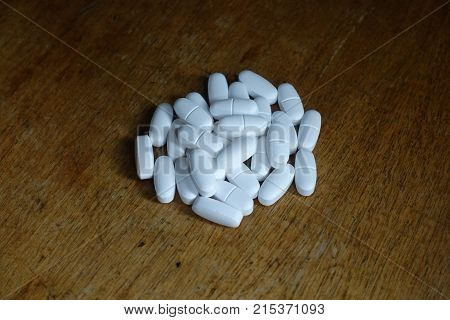 Fistful Of White Oblong Tablets Of Calcium Citrate