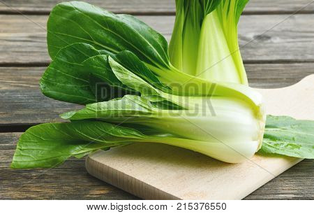 Bok choy or Chinese-cabbage on wooden board and wooden floor