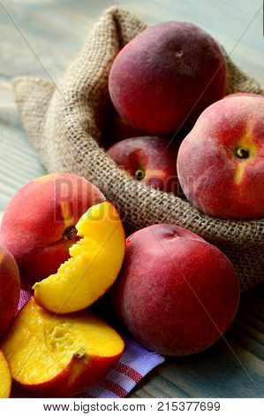 Many fresh peach in sack bag (German name is Pfirsich)