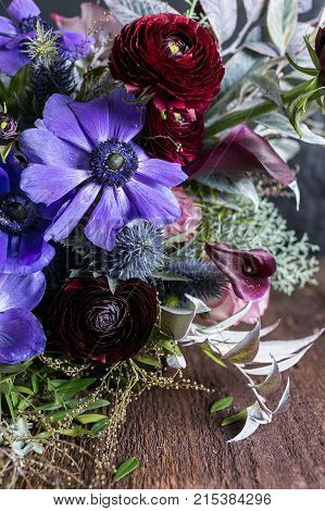 nature, tenderness, wedding decoration. absolutely different flowers are composing one wonderful unique bouquet, lilac anemons by pink lilies and persian buttercups