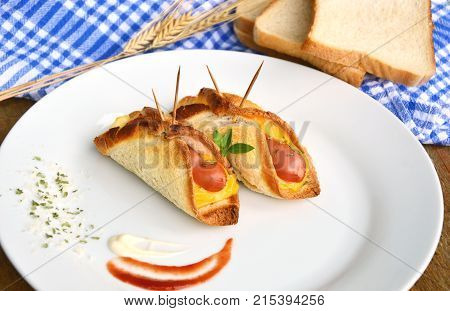 Toasted Hot Dogs and Cheese on white dish and wheat with fresh toast on wooden background