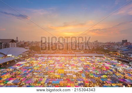 Top view night multiple colour weekend market with sunset and downtown background