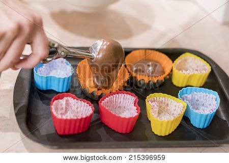 Pouring Cake Mix Into Baking Muffins Tray
