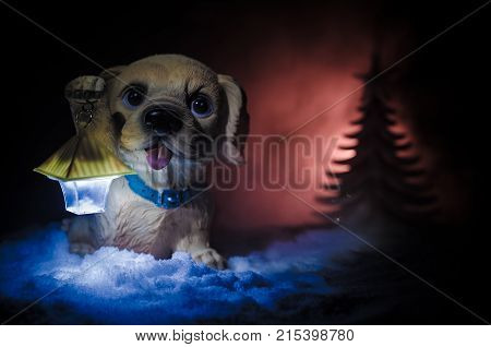 Toy Dog - A Symbol Of The New Year Under The Snow Against The Background Of Fir Branches. Toy's Dog 