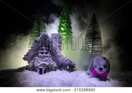Toy Dog - A Symbol Of The New Year Under The Snow Against The Background Of Fir Branches. Toy's Dog 