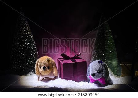 Toy Dog - A Symbol Of The New Year Under The Snow Against The Background Of Fir Branches. Toy's Dog 