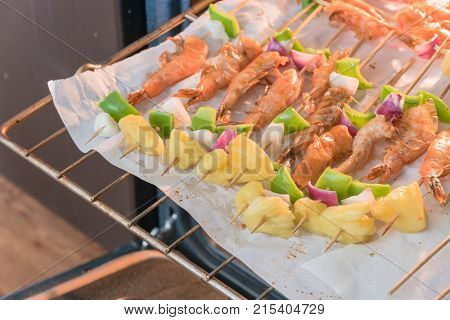 Homemade Skewer With Delicious Grilled Shrimps On Parchment Paper