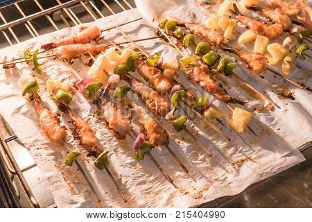 Homemade Skewer With Delicious Grilled Shrimps On Parchment Paper