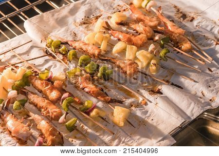 Homemade Skewer With Delicious Grilled Shrimps On Parchment Paper