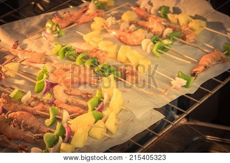 Homemade Skewer With Delicious Grilled Shrimps On Parchment Paper