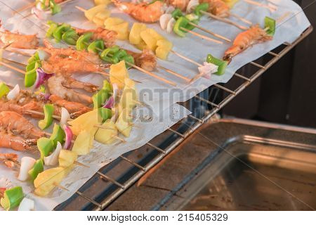 Homemade Skewer With Delicious Grilled Shrimps On Parchment Paper
