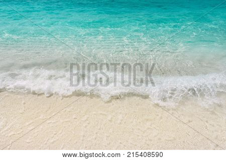 Teal blue warm sea waves shallow on white sand. Tropical beach seaside vacations. Laccadive sea resort.