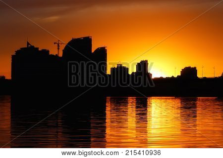 Beautiful city sunset on the background of the river