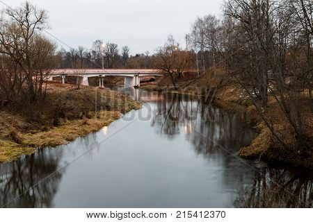 Autumn evening landscape with Istra river and car bridge. Moscow region Russia.