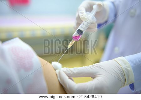 Soft focus nurses are vaccinations to patients using the syringe.Doctor vaccinating women in hospital.Are treated by the use of sterile injectable upper arm. injection