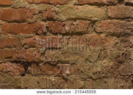 old wall of red cracked kiprich in the basement