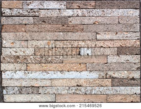 Stone wall texture, travertine tiles facing stone background