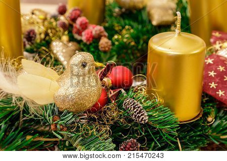 Beaty christmas decoration in the needles with candles gold birdand red balls