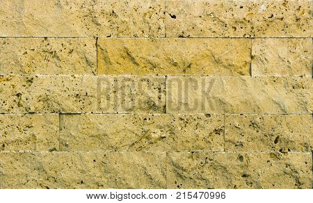 Stone wall texture, travertine tiles facing stone background