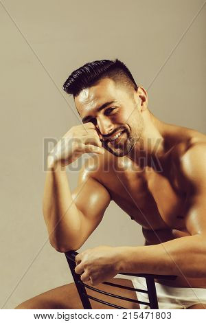 Handsome Bodybuilder Sits On Chair