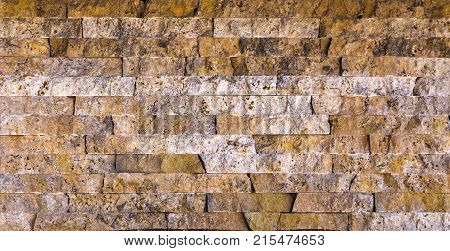 Stone wall texture, travertine tiles facing stone background