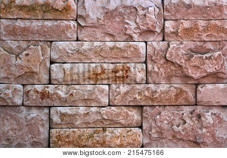 Stone wall texture, travertine tiles facing stone background