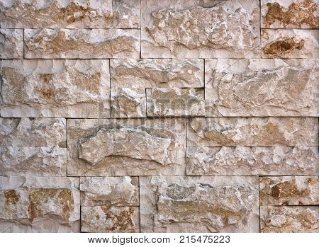 Stone wall texture, travertine tiles facing stone background
