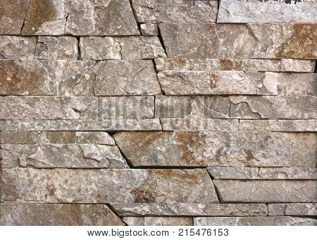 Stone wall texture, travertine tiles facing stone background