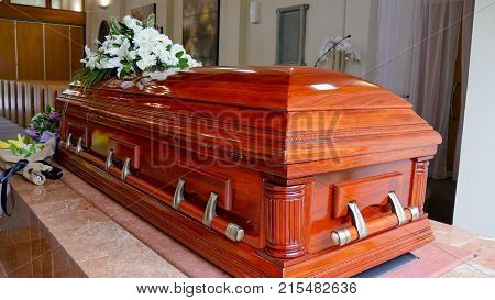 closeup shot of a colorful casket in a hearse or chapel before funeral or burial at cemetery