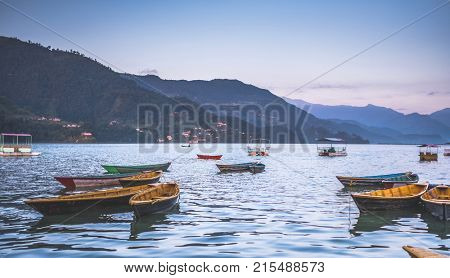 Colourful boats on the water of Phewa lake, Nepal