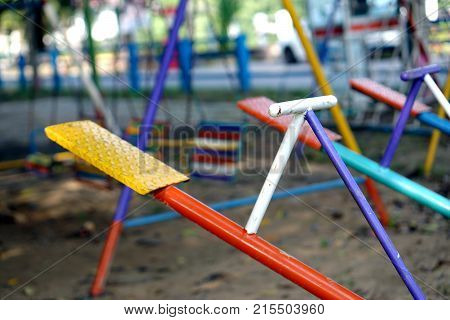 Seesaw or teeter-totter in playground for childhood