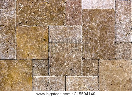 Facing tile from travertine with a smooth surface texture