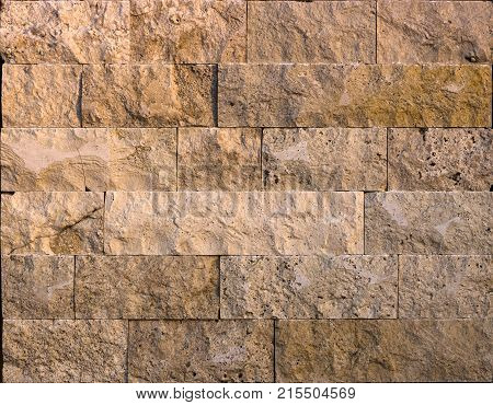 Facing tile from travertine with a smooth surface texture