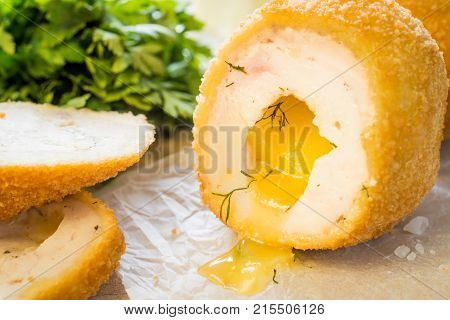 Chicken Kiev cutlets with parsley leaves and butter.