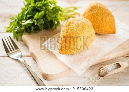 Chicken Kiev cutlets with parsley leaves and butter.