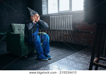 Man in tinfoil cap watch TV, telepathy phobia