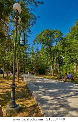 BORJOMI, GEORGIA - 07 AUGUST 2017: Borjomi town central park forest walkway by the mountain river