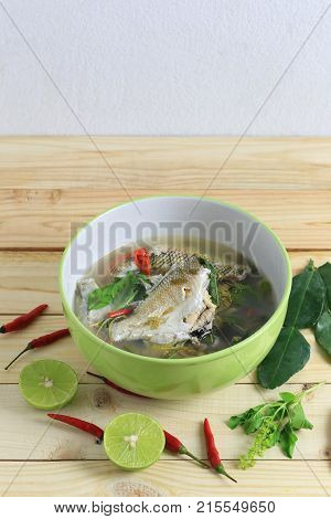 Gerres oyena or Common silver-biddy fish of hot and sour soup on wooden floor and have copy space to design in your work.