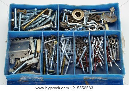 Organizer for metalware plastic box on a white wooden background. Top view.