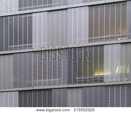 full frame detail of a house facade cased with metallic perforated plates
