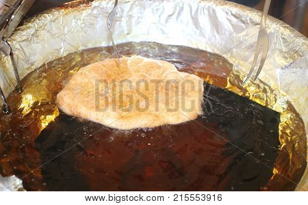 Pancake Fried In The Pot Of Hot Oil In The Stall On The Street