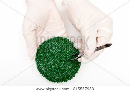 Plastic Pellets . Colorant For Polymers In Granules. Plastic Pellets In The Hands With Gloves And Tw