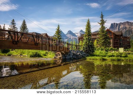 CANMORE, CANADA - JUNE 26, 2017 : Hotels in Canmore with mountain peaks in the background. Canmore is located in the Bow Valley near Banff National Park and is a popular tourist destination.