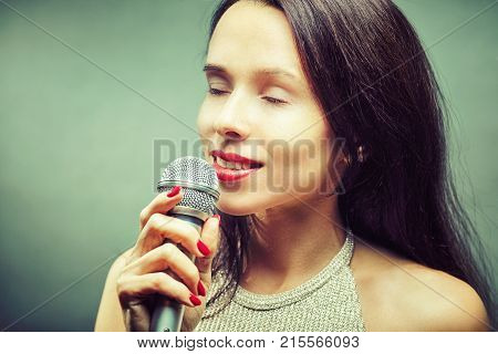 Rock star. Sexy Girl singing with mic